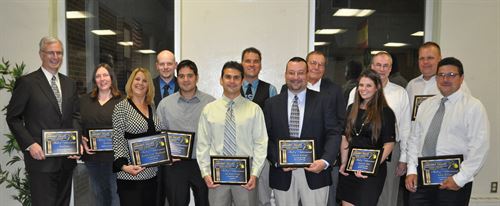 Hall of Achievement winners pose in a group with their plaques